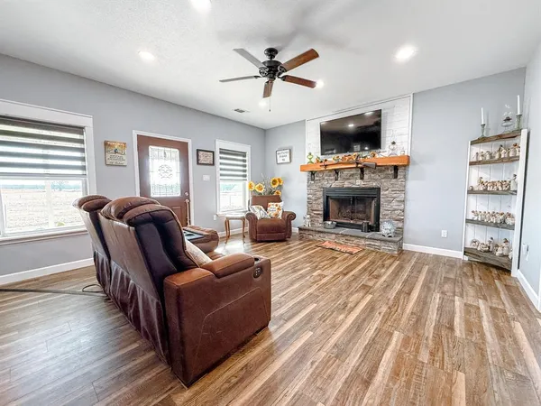 a living room with furniture fireplace and flat screen tv
