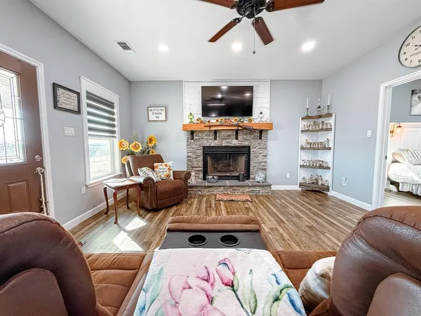 a living room with furniture fireplace and flat screen tv