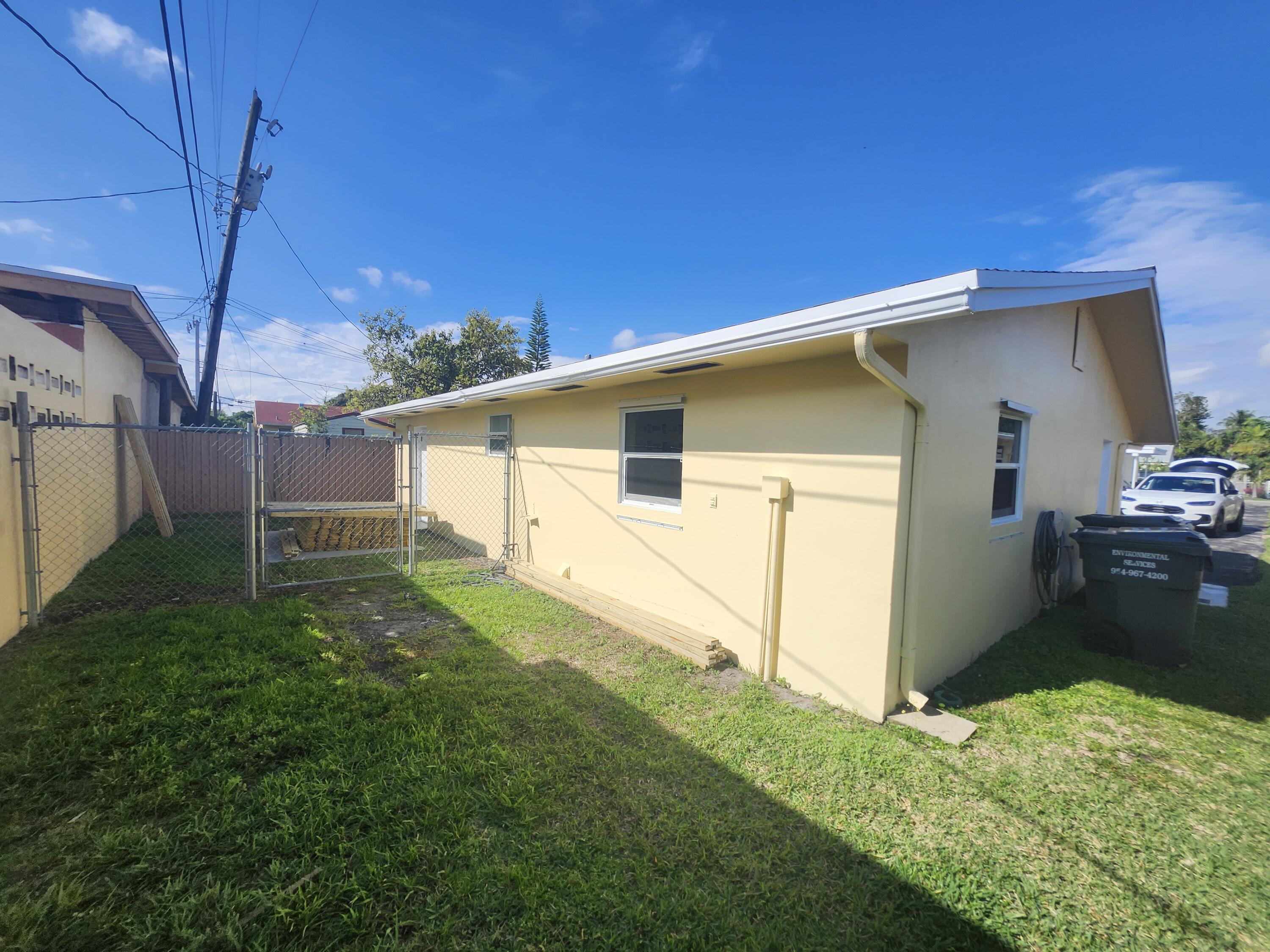 511 Northwest 60th Way, Unit EAST APARTMENT Hollywood, FL 33024 - Photo 14 of 15 a house view with a backyard space