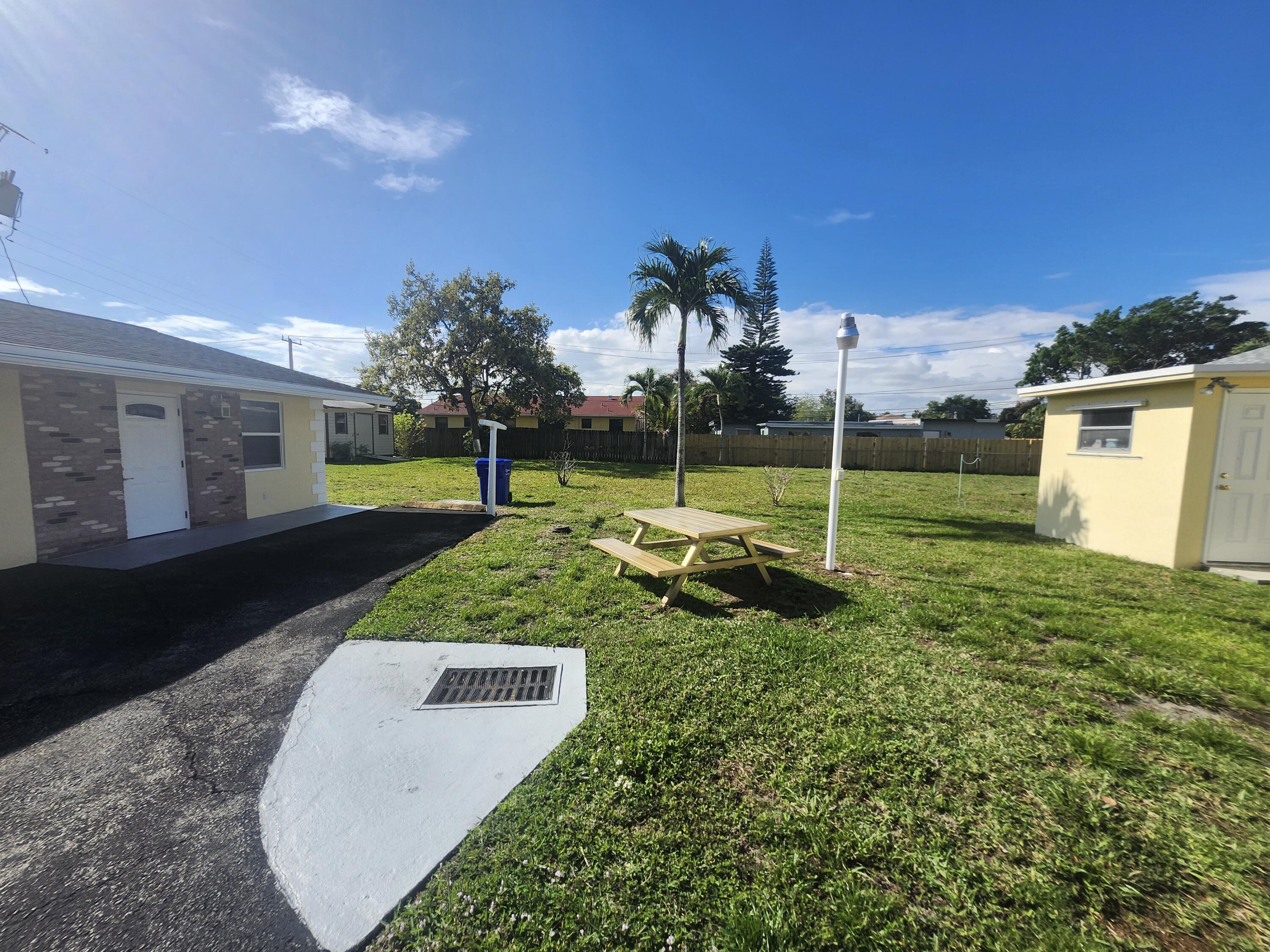 511 Northwest 60th Way, Unit EAST APARTMENT Hollywood, FL 33024 - Photo 4 of 15 a view of a park with swings
