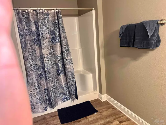 a view of a small space with wooden floor and a window