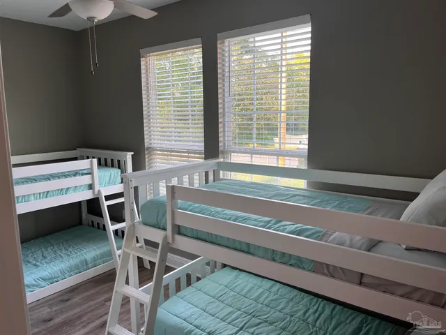 a view of a room with wooden floor and windows