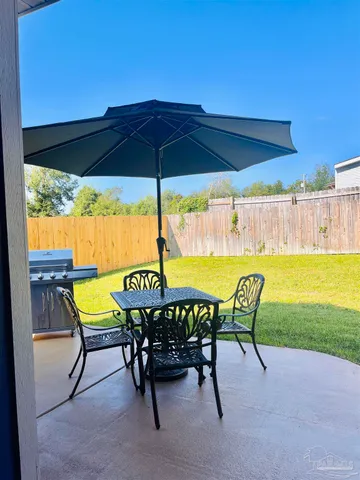 a view of a table and chairs under an umbrella