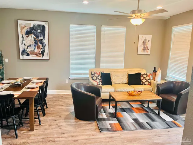 a view of a dining room with furniture window and wooden floor