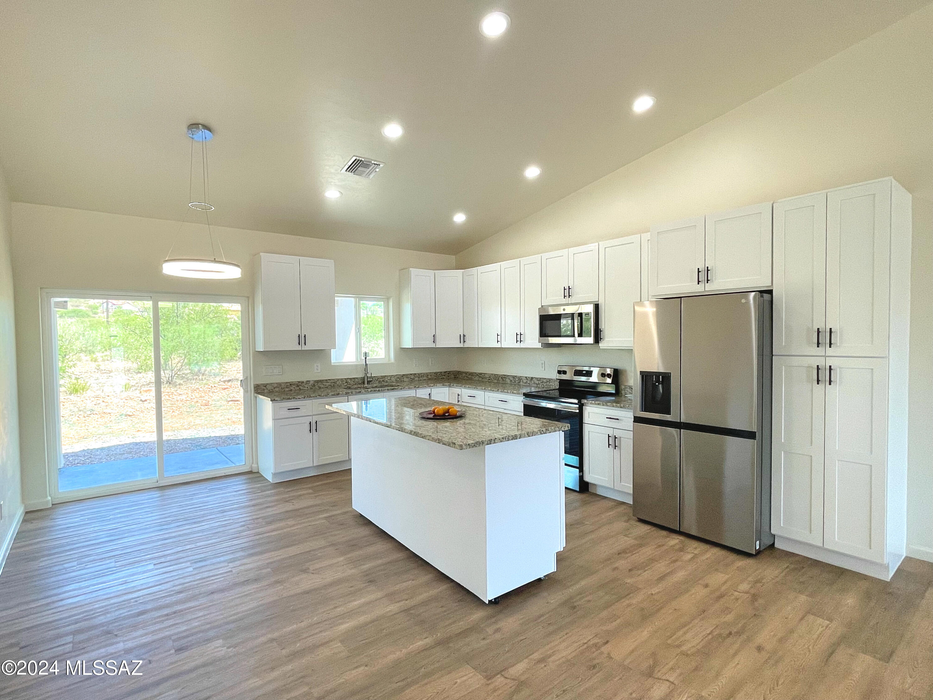 1835 San Diego Court Rio Rico, AZ 85648 - Photo 4 of 19 a kitchen with refrigerator and cabinets