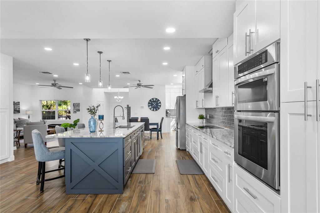 13830 Lake Mary Jane Road Orlando, FL 32832 - Photo 17 of 99 a kitchen with stainless steel appliances kitchen island granite countertop a large island in the center