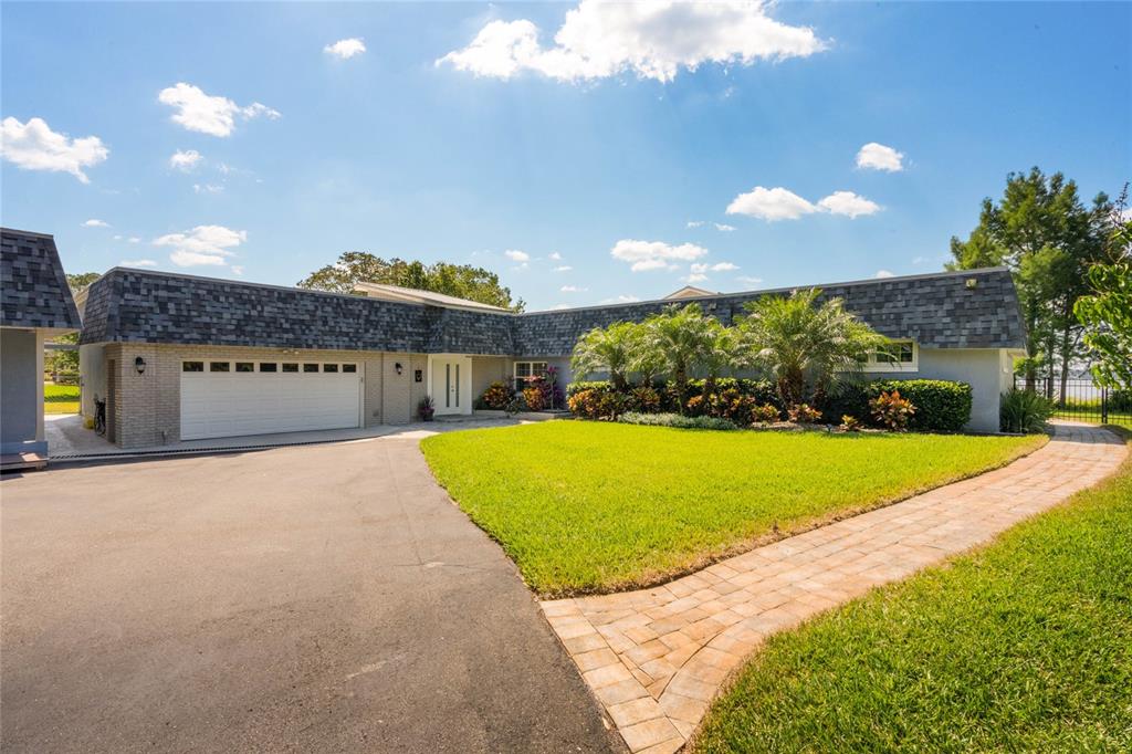 13830 Lake Mary Jane Road Orlando, FL 32832 - Photo 2 of 99 a view of a house with a yard and potted plants