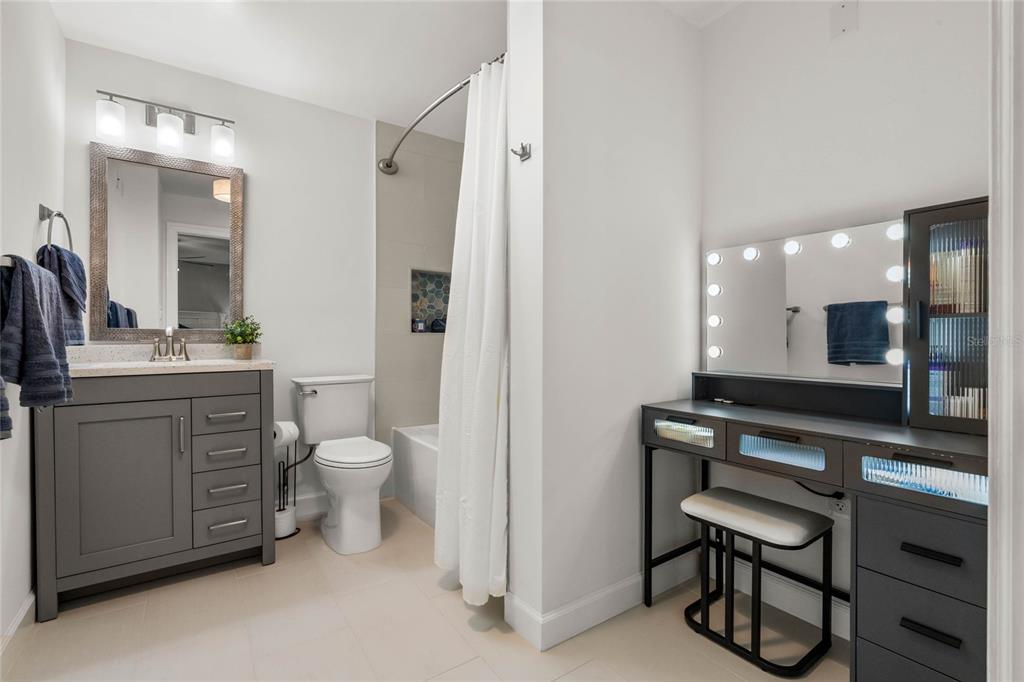 13830 Lake Mary Jane Road Orlando, FL 32832 - Photo 29 of 99 a bathroom with a toilet a sink a mirror and a shower