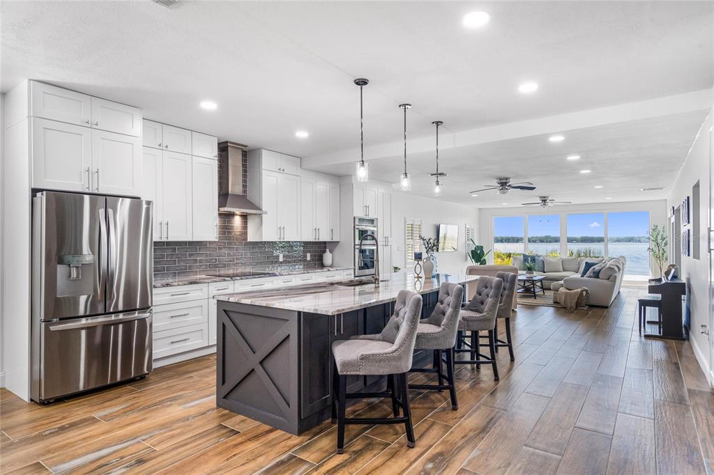 13830 Lake Mary Jane Road Orlando, FL 32832 - Photo 3 of 99 a kitchen with a table chairs stainless steel appliances and cabinets