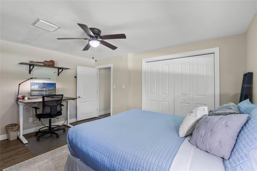 13830 Lake Mary Jane Road Orlando, FL 32832 - Photo 34 of 99 a bedroom with a bed and a chandelier