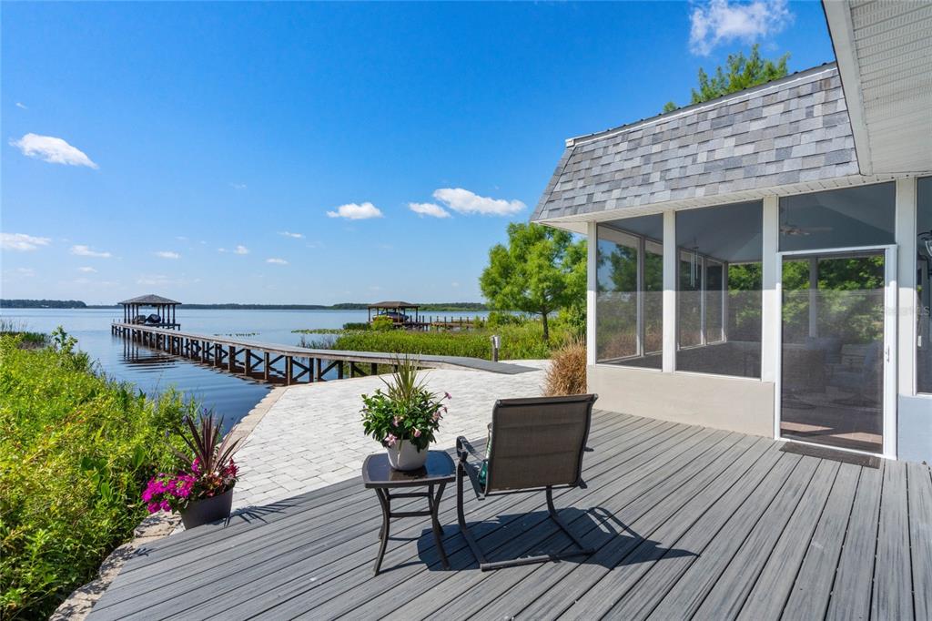 13830 Lake Mary Jane Road Orlando, FL 32832 - Photo 54 of 99 a view of a chairs and table on the wooden deck