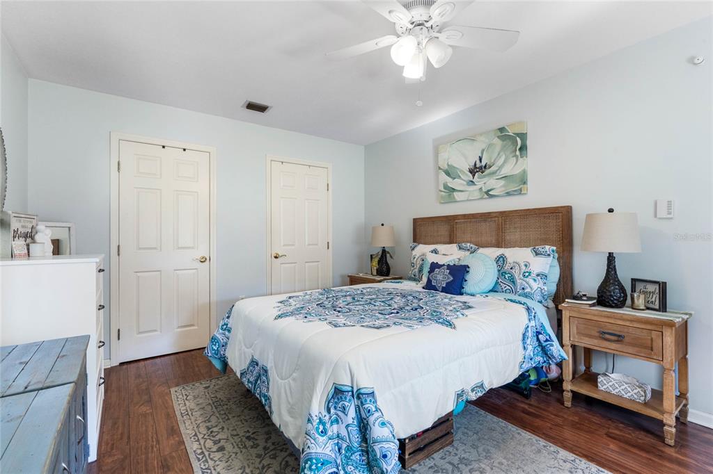13830 Lake Mary Jane Road Orlando, FL 32832 - Photo 66 of 99 a bedroom with a bed and a chandelier