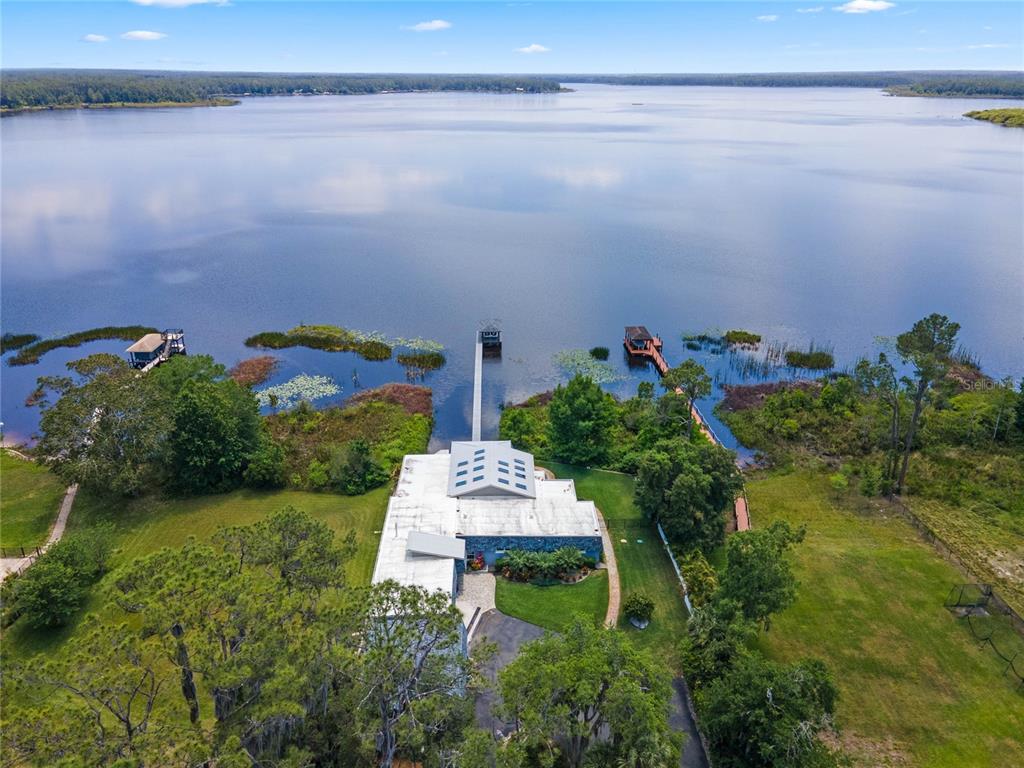 13830 Lake Mary Jane Road Orlando, FL 32832 - Photo 84 of 99 a backyard of a house with lots of green space and lake view