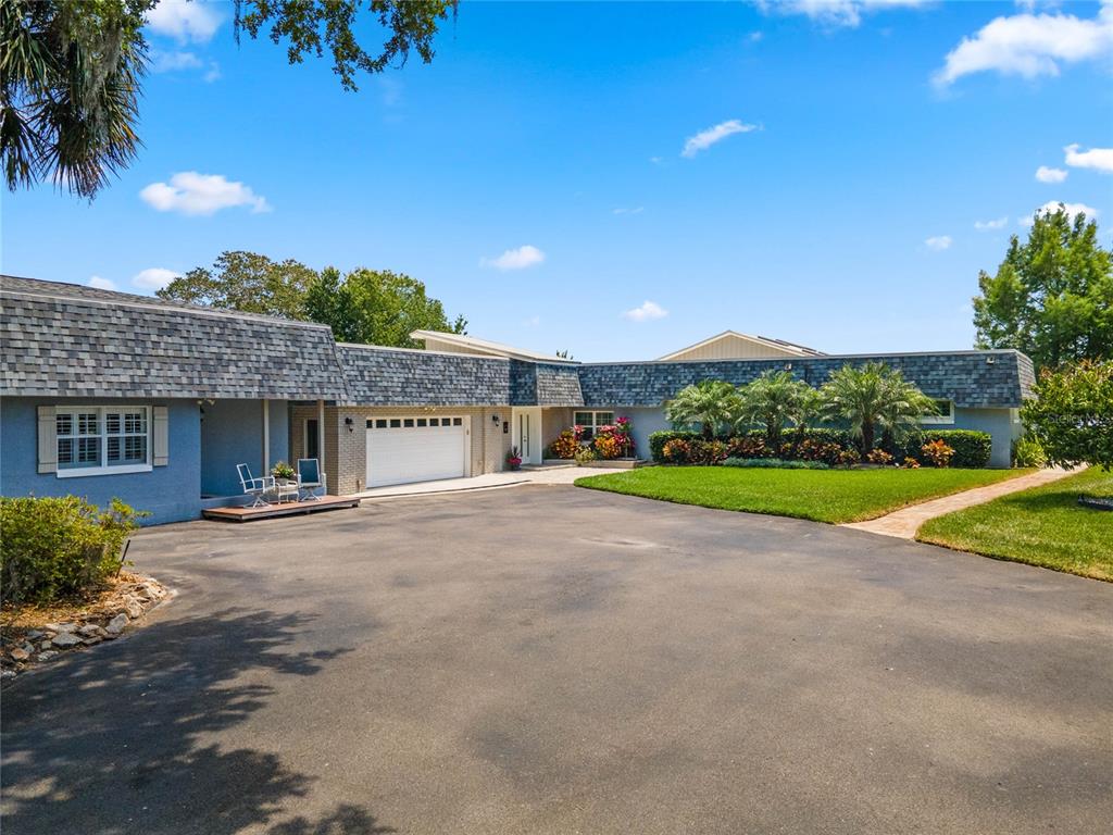 13830 Lake Mary Jane Road Orlando, FL 32832 - Photo 9 of 99 a view of a house with a yard and potted plants
