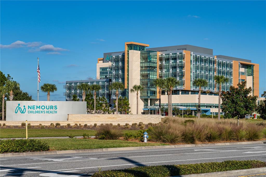 13830 Lake Mary Jane Road Orlando, FL 32832 - Photo 94 of 99 a front view of a building with garage and yard