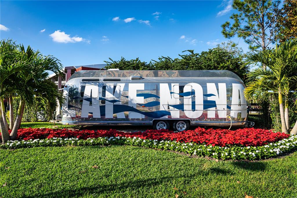13830 Lake Mary Jane Road Orlando, FL 32832 - Photo 95 of 99 a front view of a house with a big yard and potted plants