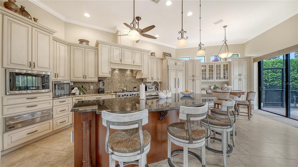 1630 Assisi Drive, Unit 18 Sarasota, FL 34231 - Photo 10 of 42 a large kitchen with a large window and cabinets