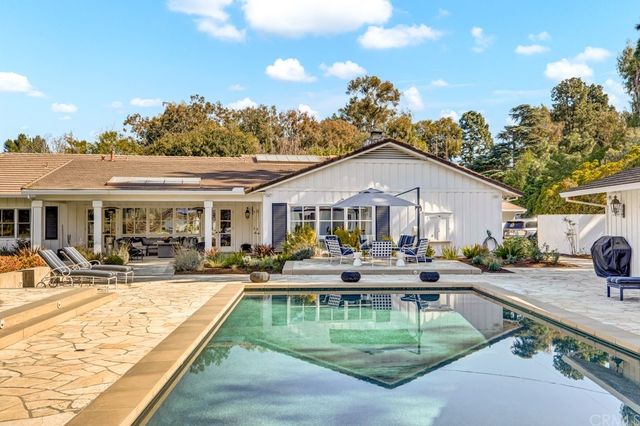 a swimming pool view with a outdoor seating