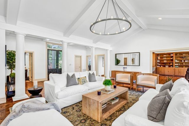 a living room with furniture a rug and a chandelier