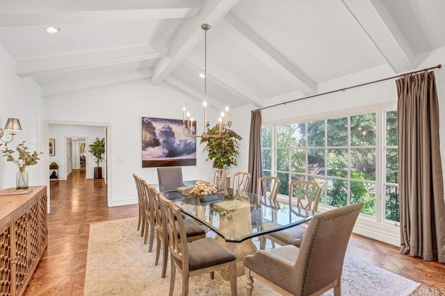 a dining room with furniture wooden floor and a rug