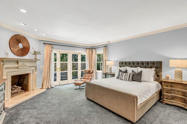 a spacious bedroom with a bed and a fireplace