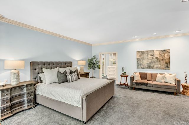 a spacious bedroom with a bed and a couch