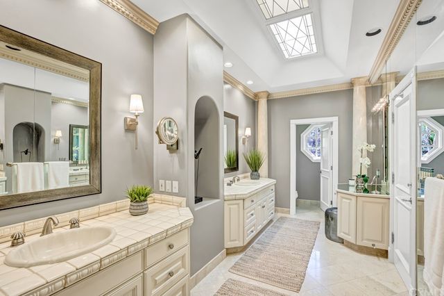 a spacious bathroom with a granite countertop sink and a mirror