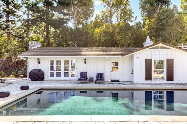 a living room with furniture a fireplace and a table