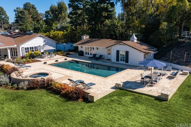 a view of a house with backyard and sitting area