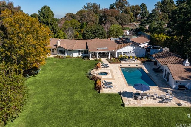a aerial view of a house with a garden and trees