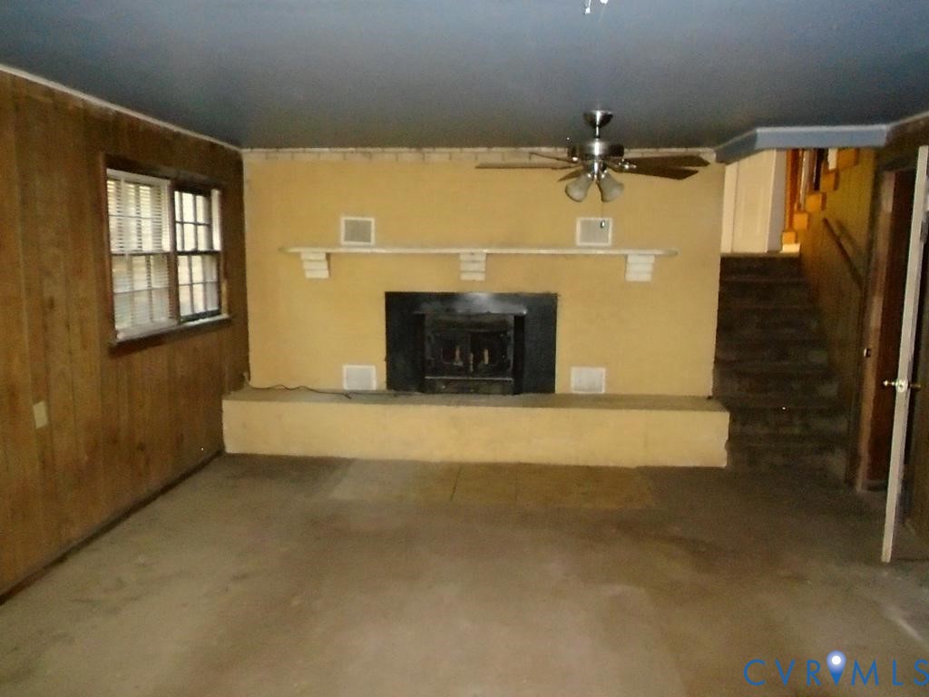 16203 West Patrick Henry Road Montpelier, VA 23192 - Photo 4 of 23 Living area featuring a central fireplace with a b