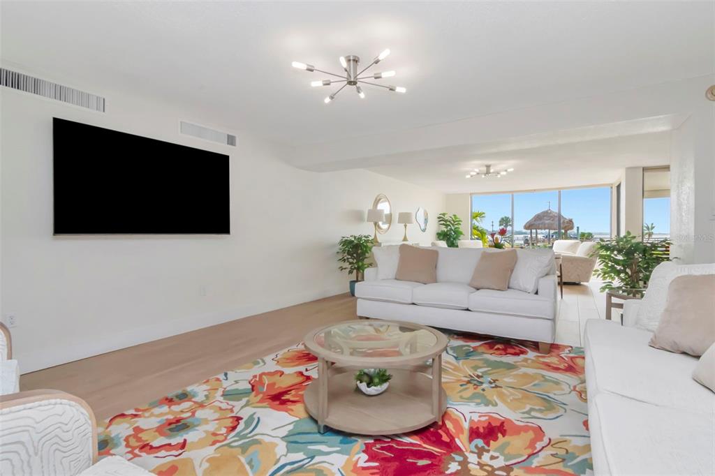 634 Edgewater Drive, Unit 848 Dunedin, FL 34698 - Photo 12 of 40 a living room with furniture and a flat screen tv