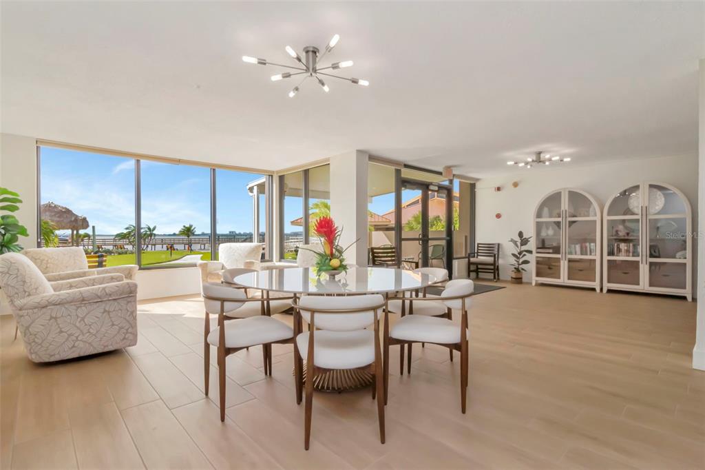634 Edgewater Drive, Unit 848 Dunedin, FL 34698 - Photo 13 of 40 a living room with fireplace furniture and a floor to ceiling window
