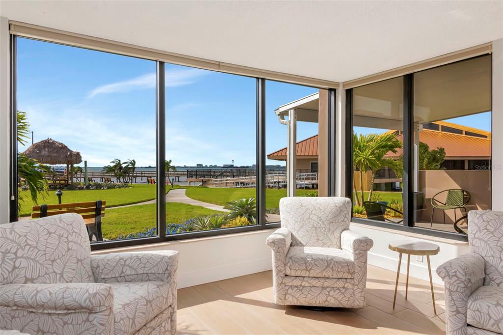 634 Edgewater Drive, Unit 848 Dunedin, FL 34698 - Photo 14 of 40 a living room with couch and a view of balcony