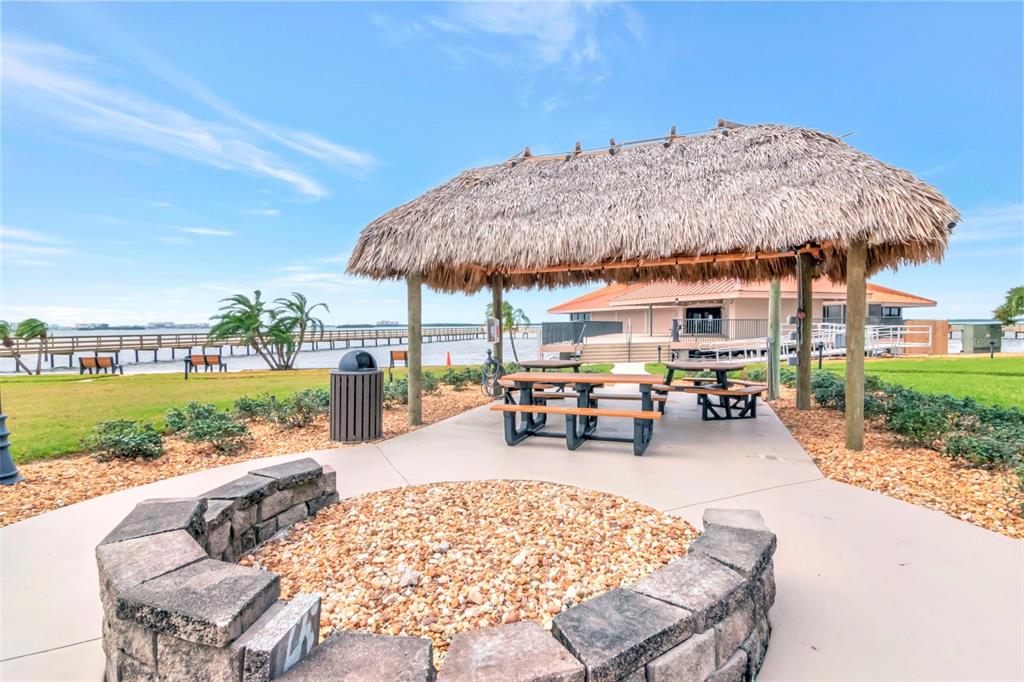 634 Edgewater Drive, Unit 848 Dunedin, FL 34698 - Photo 21 of 40 an outdoor space with patio lots of furniture and lake view