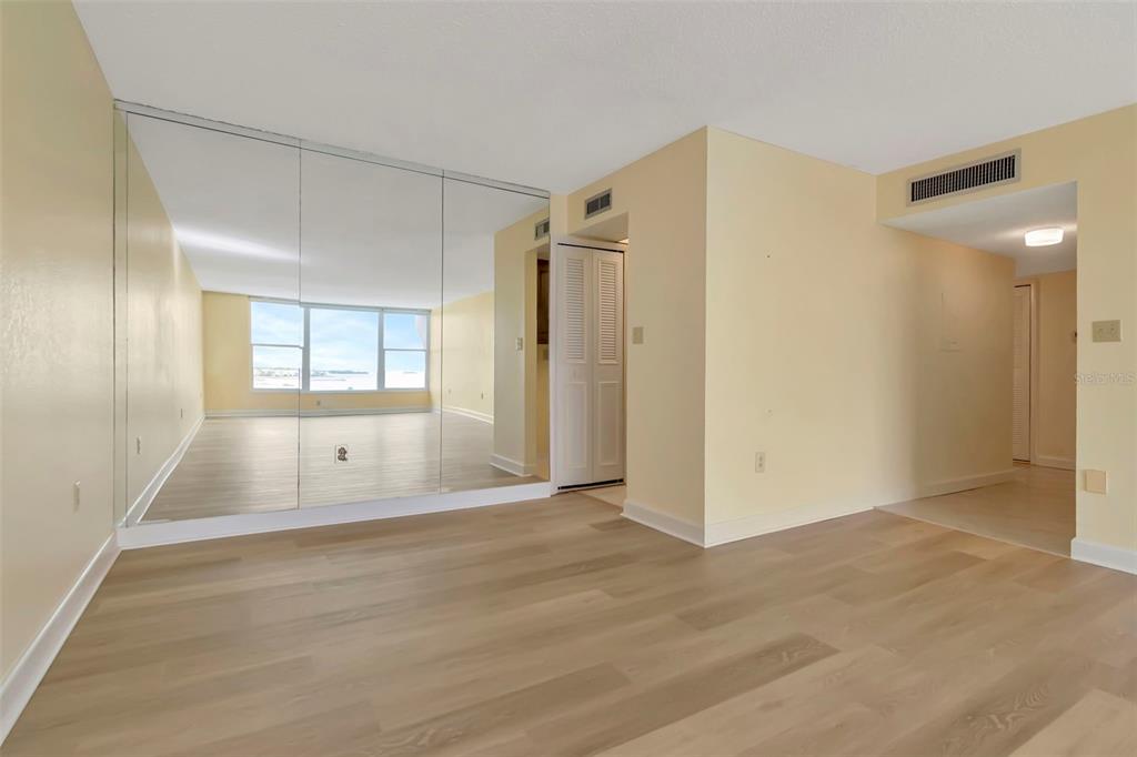 634 Edgewater Drive, Unit 848 Dunedin, FL 34698 - Photo 6 of 40 a view of empty room with wooden floor and fan
