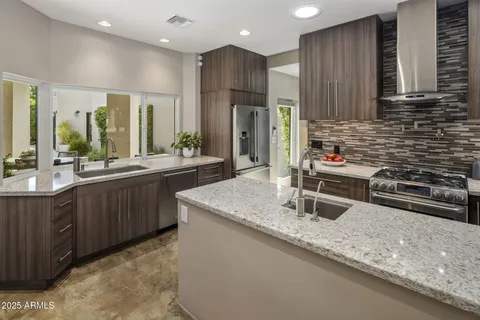 a kitchen with stainless steel appliances granite countertop a stove and a microwave