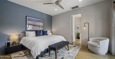 a kitchen with a sink and chairs