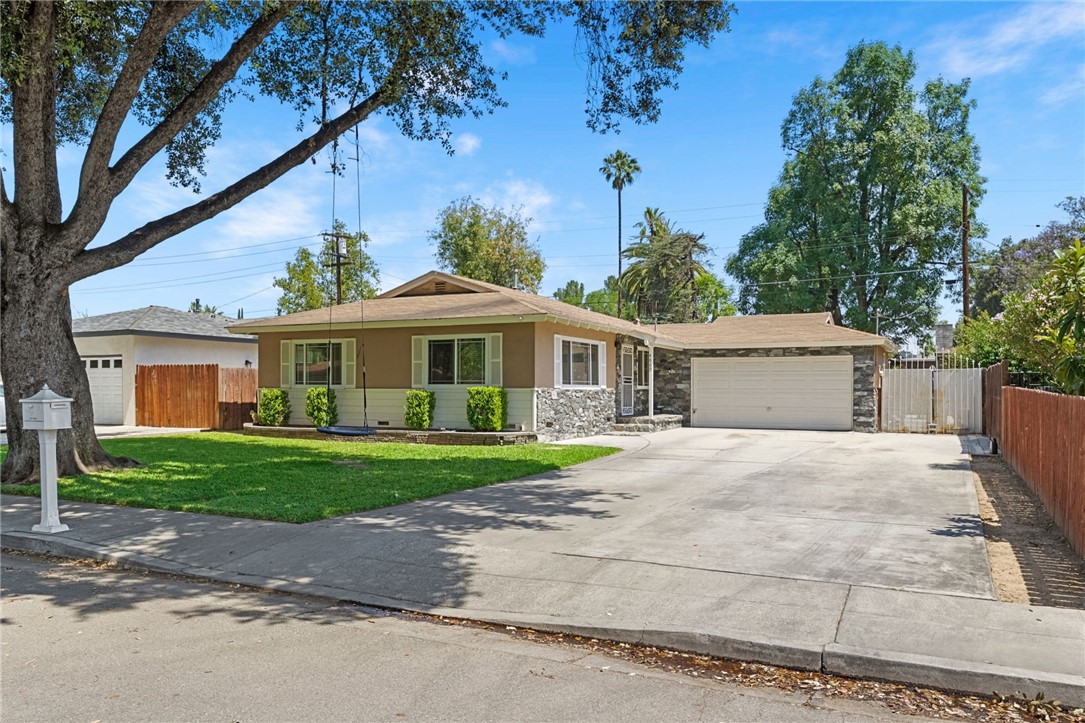 4869 Serrano Place Riverside, CA 92504 - Photo 10 of 40 Charming single-story home with great curb appeal, a wide driveway, mature shade trees, and a welcoming front lawn.
