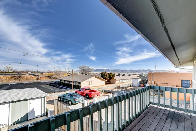 a view of a house with wooden roof and wooden fence