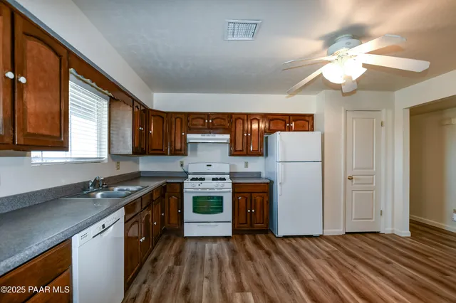 a kitchen with stainless steel appliances granite countertop a stove and a sink