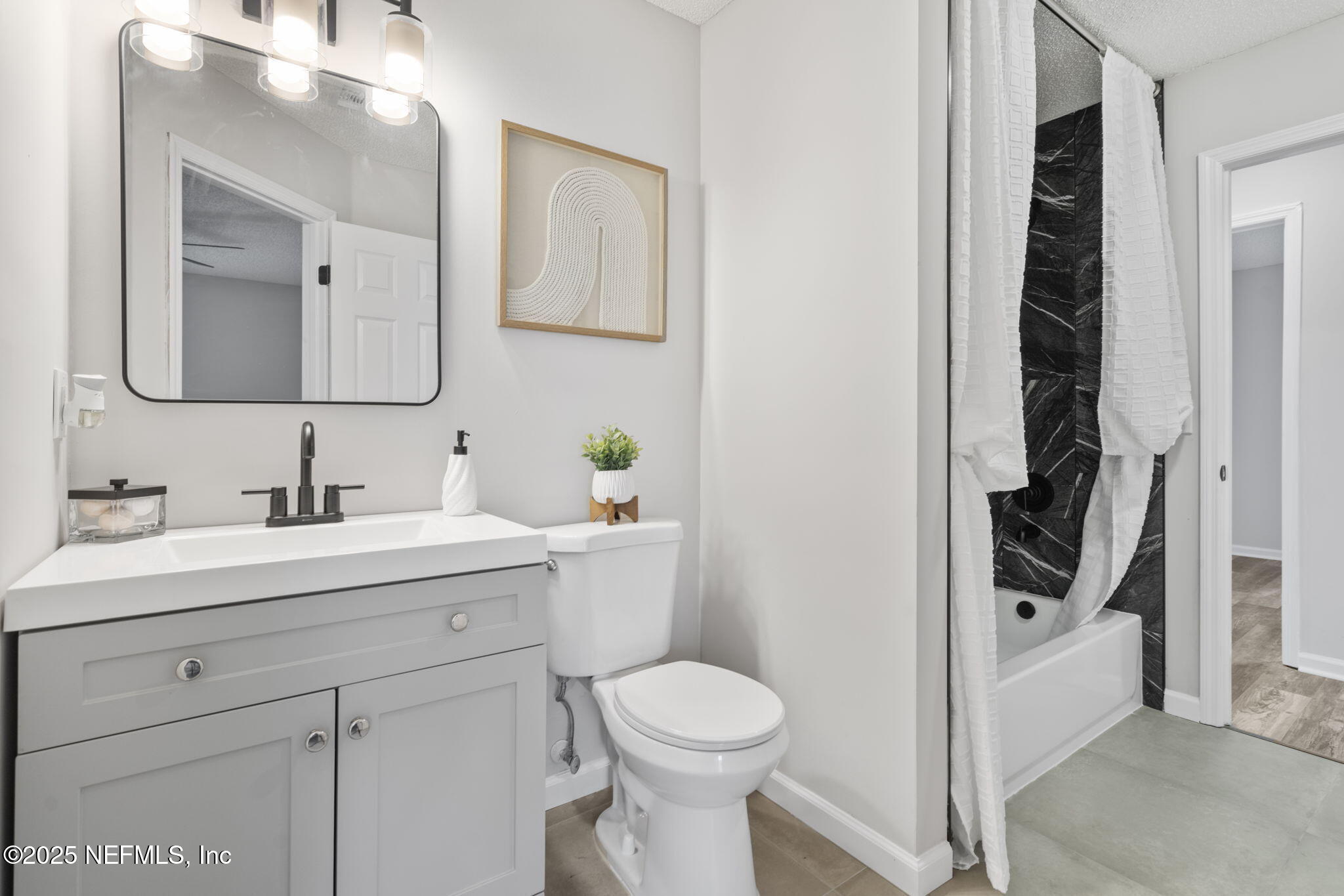 2987 Quapaw Trail Middleburg, FL 32068 - Photo 17 of 32 a bathroom with a toilet sink and mirror