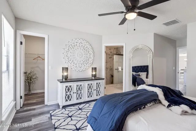 a bathroom with a granite countertop sink a mirror and shower