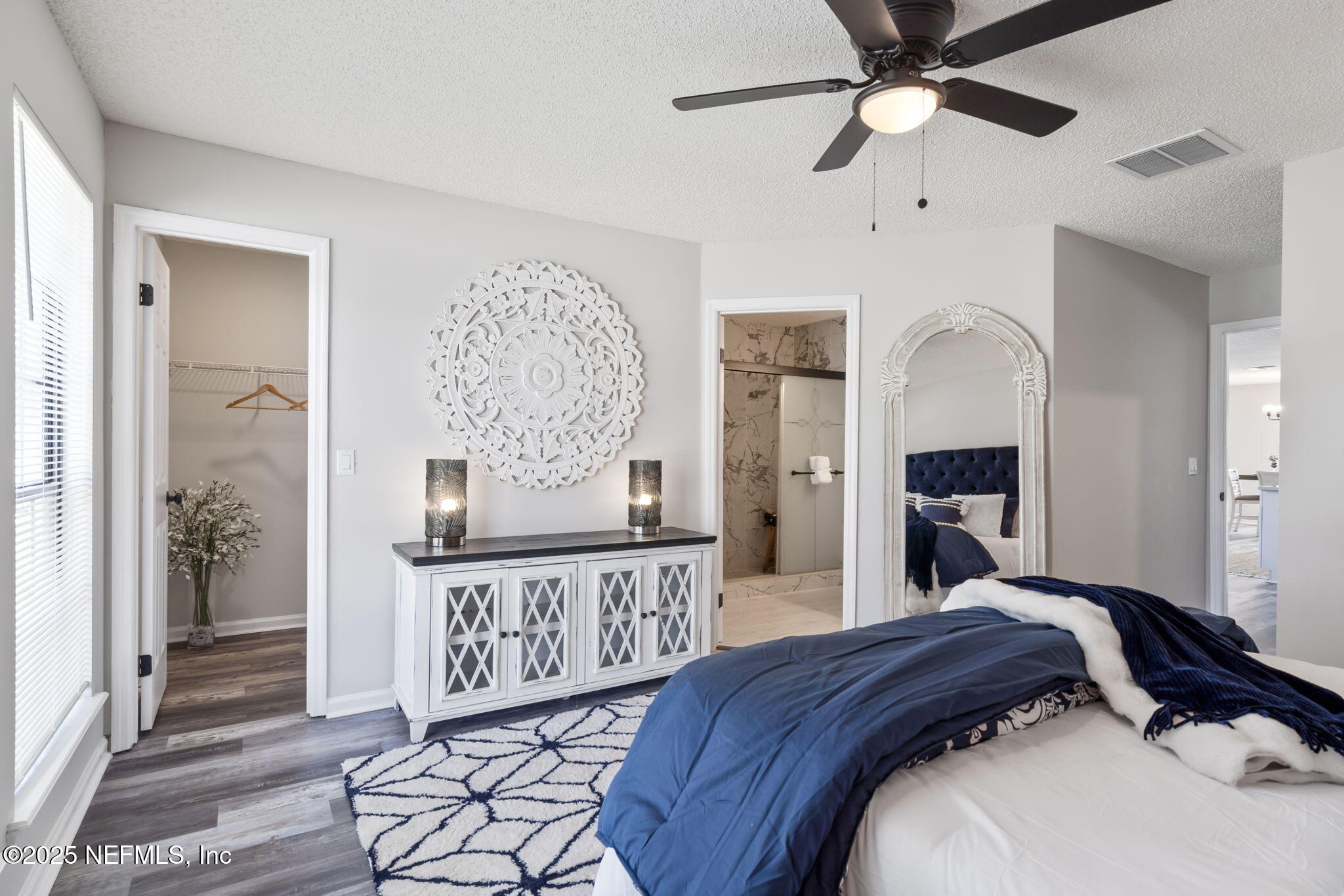 2987 Quapaw Trail Middleburg, FL 32068 - Photo 22 of 32 a bedroom with a bed a mirror on the dresser and a window