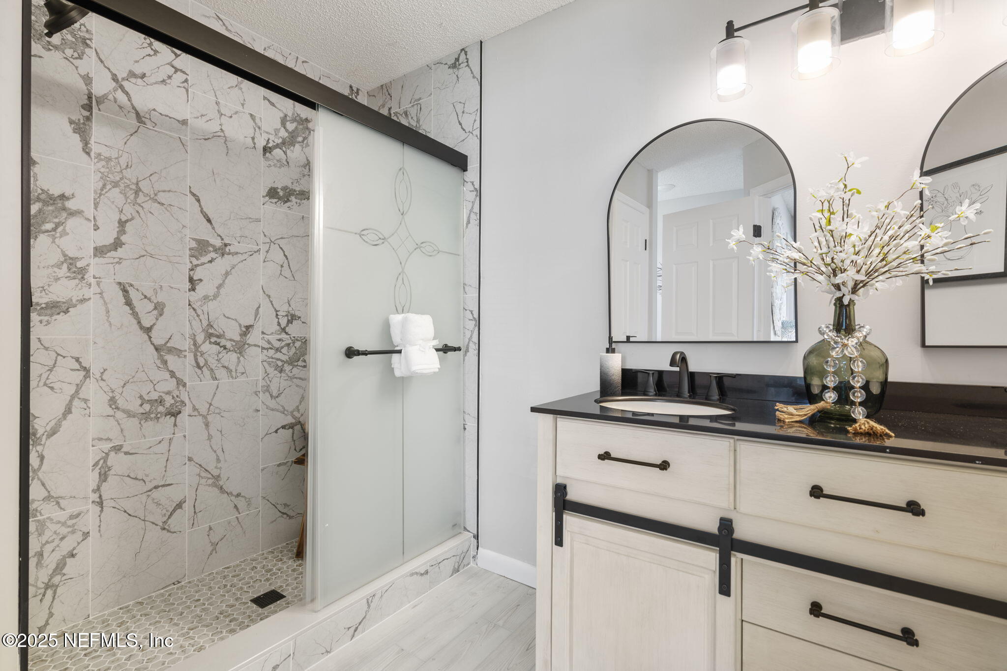 2987 Quapaw Trail Middleburg, FL 32068 - Photo 23 of 32 a bathroom with a granite countertop sink a mirror and shower