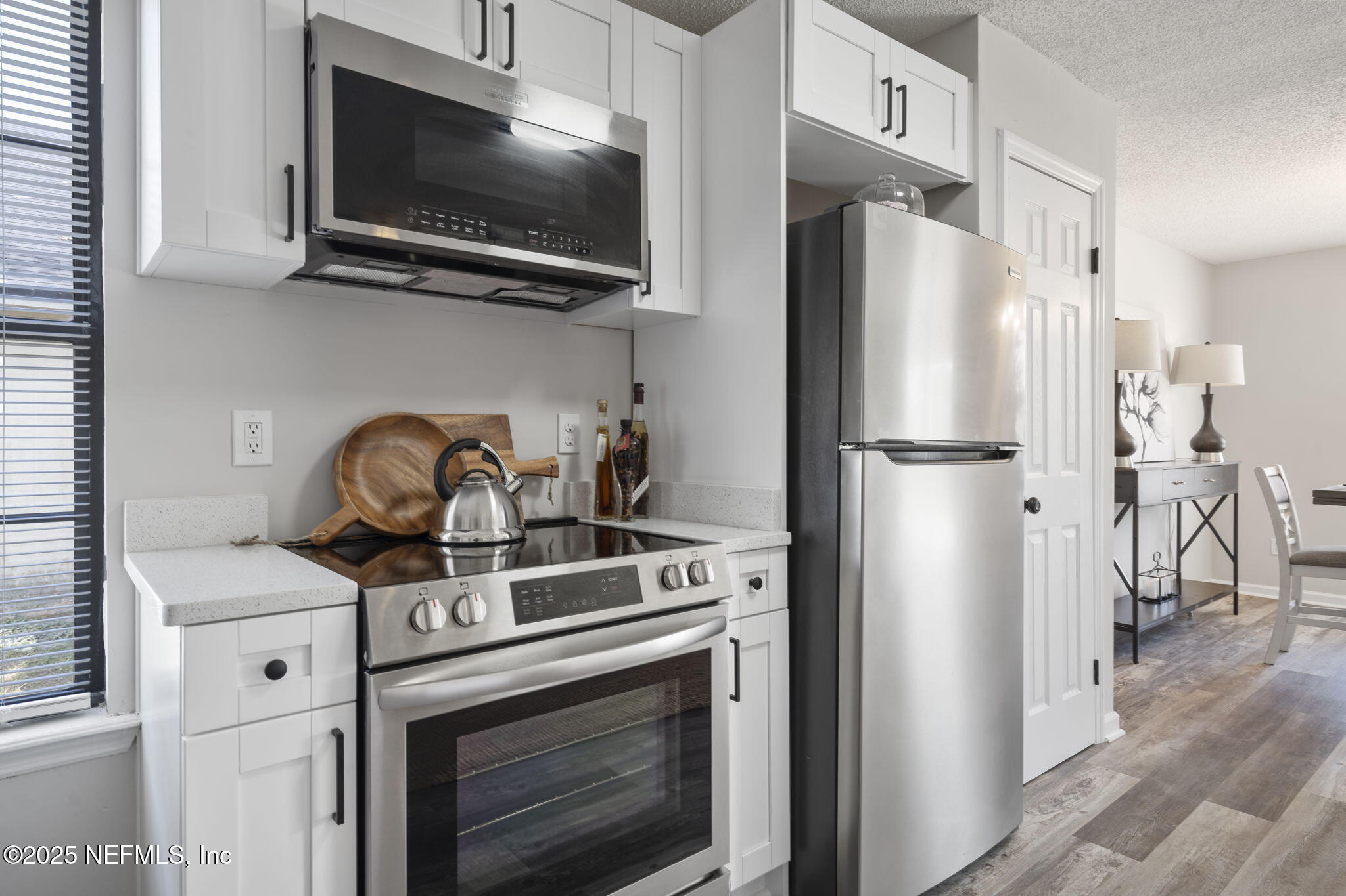 2987 Quapaw Trail Middleburg, FL 32068 - Photo 7 of 32 a kitchen with stainless steel appliances a stove a microwave and a refrigerator