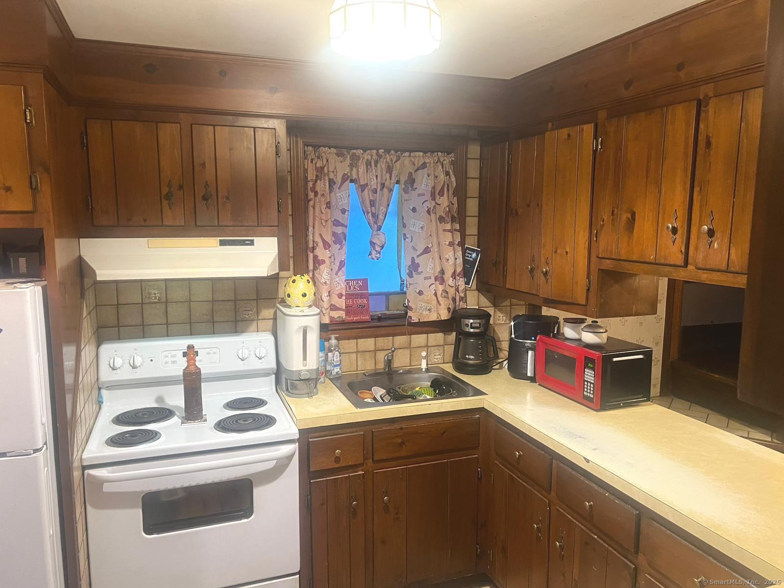 178 Elm Street Meriden, CT 06450 - Photo 3 of 18 a kitchen with a stove and a sink