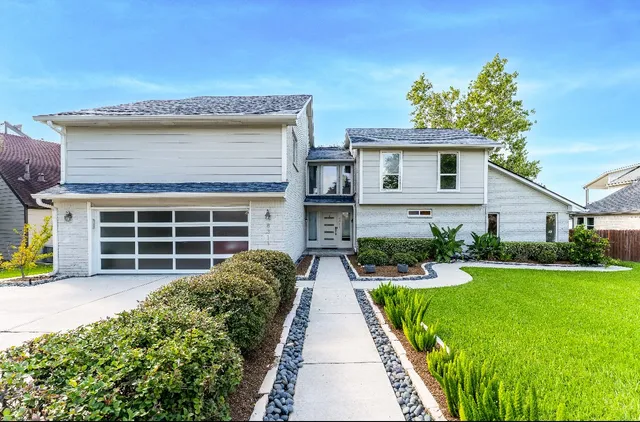 a front view of a house with a yard and porch