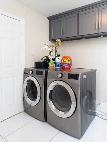 a utility room with sink dryer and washer