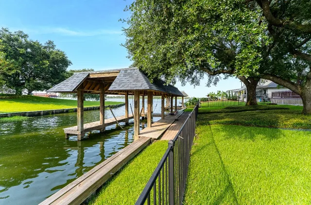a view of swimming pool with lawn chairs and a yard